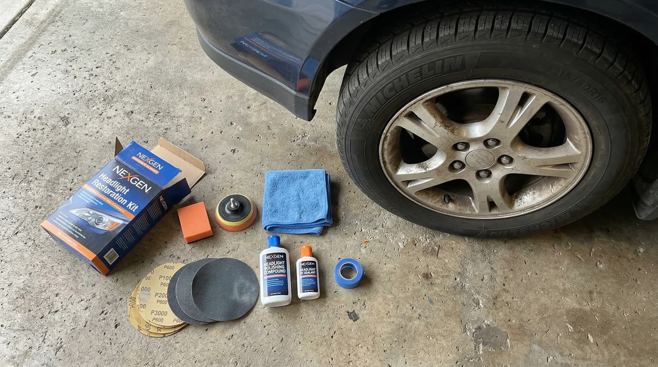 Headlight restoration kit next to a wheel.